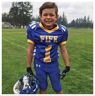 A football player wearing a blue and red jersey. Description generated by AI