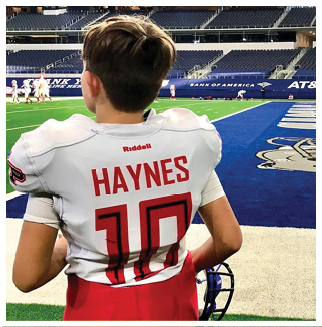 A football player wearing a blue and red jersey. Description generated by AI