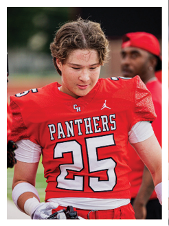 Two football players wearing black jerseys and holding hands. Description generated by AI