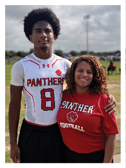 Two football players wearing black jerseys and holding hands. Description generated by AI