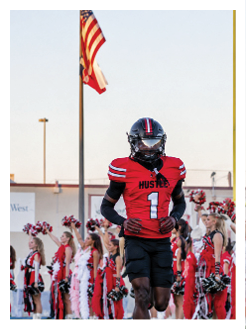 Two football players wearing black jerseys and holding hands. Description generated by AI