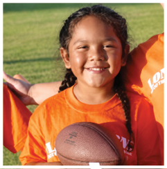 A football player wearing a blue and red jersey. Description generated by AI