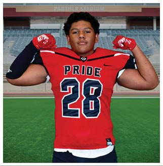A football player wearing a blue and red jersey. Description generated by AI