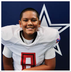 A football player wearing a blue and red jersey. Description generated by AI