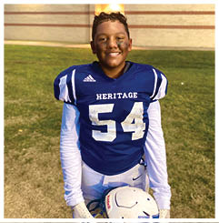 A football player wearing a blue and red jersey. Description generated by AI