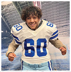 A football player wearing a blue and red jersey. Description generated by AI