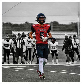 A football player wearing a blue and red jersey. Description generated by AI