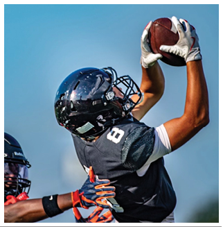 A football player wearing a blue and red jersey. Description generated by AI