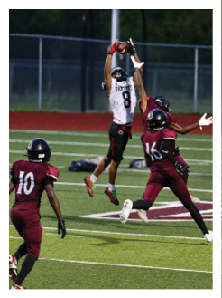 Two football players wearing black jerseys and holding hands. Description generated by AI