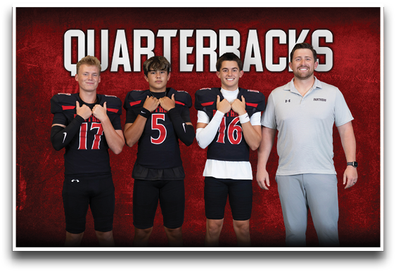 Three people in football uniforms and one person in a polo shirt stand in front of a red background with the word “QUARTERBACKS" above them. Description generated by AI