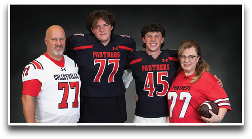 Four people wearing football jerseys with the numbers 77 and 45 pose together against a dark background, with one person holding a football. Description generated by AI