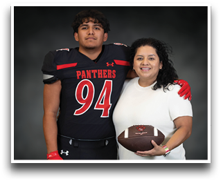 A person wearing a black football uniform with the number 94 and the word Panthers stands with an arm around another person in a white shirt holding a football, both smiling against a dark background. Description generated by AI