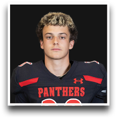 Person with curly hair wearing a black and red football jersey with the word Panthers on the front. Description generated by AI