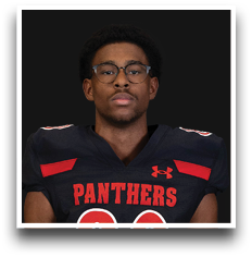 Person wearing glasses and a black football jersey with red accents and the word “PANTHERS" on the front. Description generated by AI