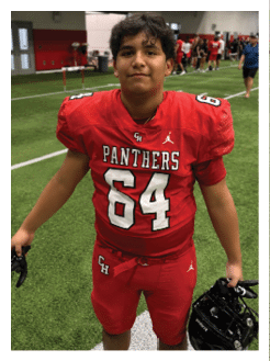 Two football players wearing black jerseys and holding hands. Description generated by AI