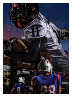 Two football players wearing black jerseys and holding hands. Description generated by AI