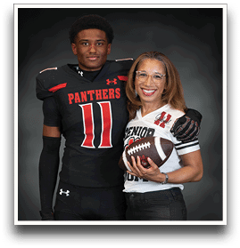 A person in a football uniform with the word Panthers and number 11 stands next to another person wearing glasses and a senior football jersey holding a football, both smiling against a dark background. Description generated by AI