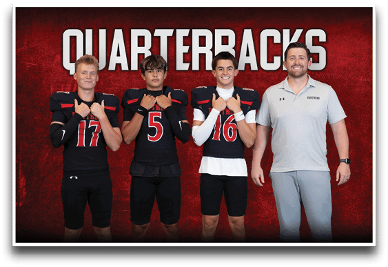 Three people in football uniforms and one person in a polo shirt stand in front of a red background with the word “QUARTERBACKS" above them. Description generated by AI