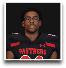 Person wearing glasses and a black football jersey with red accents and the word “PANTHERS" on the front. Description generated by AI