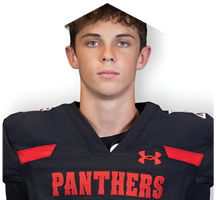 A person wearing a black sports jersey with red accents and the word “PANTHERS" written in red across the chest. Description generated by AI