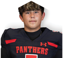 Person wearing a dark sports jersey with the word “PANTHERS" in red letters and a red Under Armour logo. Description generated by AI