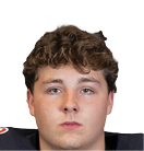 A person with curly hair wearing a black football jersey with red and white lettering that says Panthers and the number 52 stands facing forward. Description generated by AI