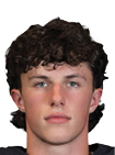Person with curly hair wearing a black football jersey with red and white accents and the number 45 standing against a white background. Description generated by AI
