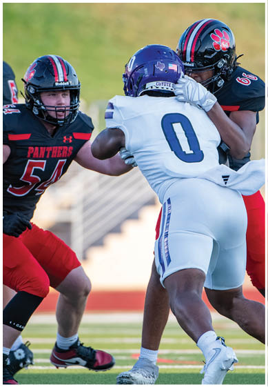 A football player wearing a blue jersey with the number 58 on it. Description generated by AI