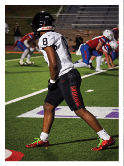 Two football players wearing black jerseys and holding hands. Description generated by AI