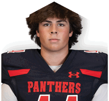 A person with medium-length hair wearing a black sports jersey with red accents and the word “PANTHERS" across the chest. Description generated by AI