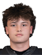 A person with short, tousled hair is wearing a black football jersey with the number 55 and the word Panthers on the front. Description generated by AI