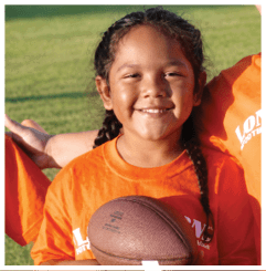 A football player wearing a blue and red jersey. Description generated by AI