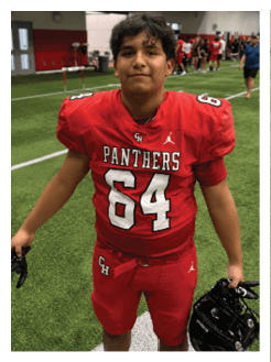 Two football players wearing black jerseys and holding hands. Description generated by AI