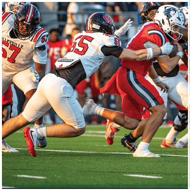 A person wearing a black football helmet and white jersey with the number 17 is preparing to throw a football. Description generated by AI
