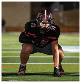 A football player wearing a blue and red jersey. Description generated by AI