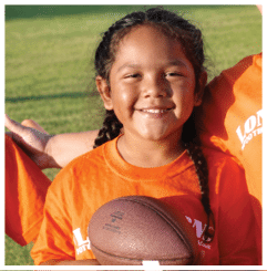 A football player wearing a blue and red jersey. Description generated by AI