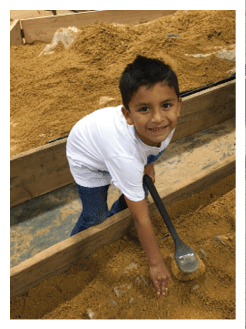 Two football players wearing black jerseys and holding hands. Description generated by AI