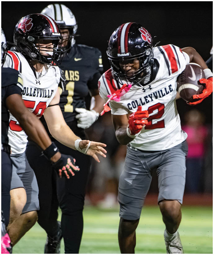 A person wearing a Colleyville football uniform is running with a football while other players in different uniforms are nearby on a lit field. Description generated by AI