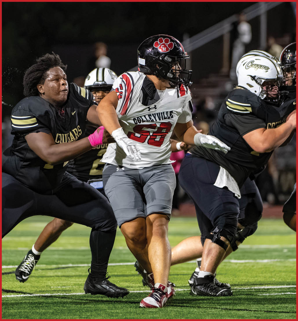People in football uniforms are actively engaged in a play on a well-lit field during a nighttime game. Description generated by AI