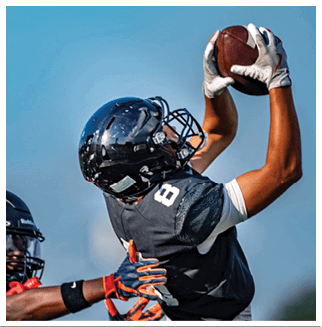 A football player wearing a blue and red jersey. Description generated by AI