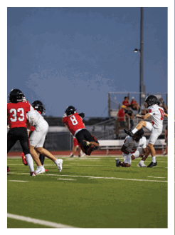 Two football players wearing black jerseys and holding hands. Description generated by AI