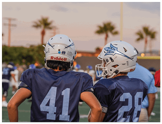 A group of football players on a field. Description generated by AI