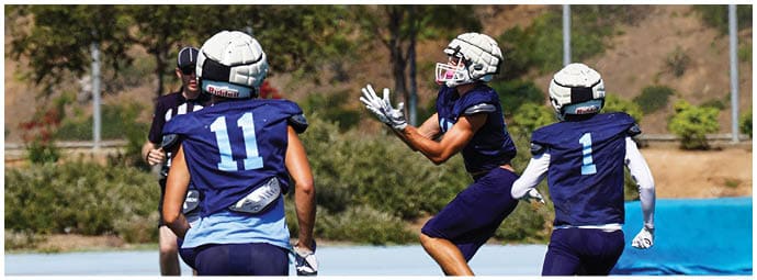A football player wearing a blue and white uniform. Description generated by AI