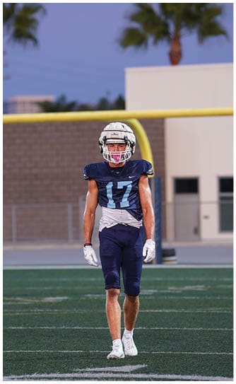 A football player catching a ball. Description generated by AI