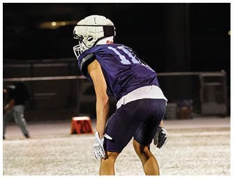 A group of football players on a field. Description generated by AI