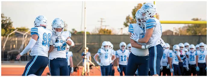 A football player wearing a blue and white uniform. Description generated by AI