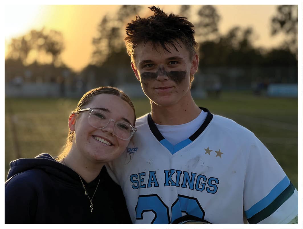 A football player wearing a blue and red jersey. Description generated by AI