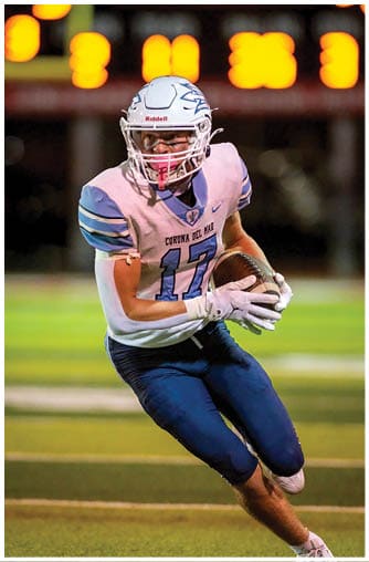 A football player running on the field. Description generated by AI