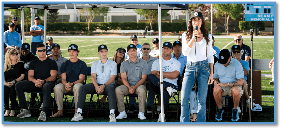 A group of football players on a field. Description generated by AI