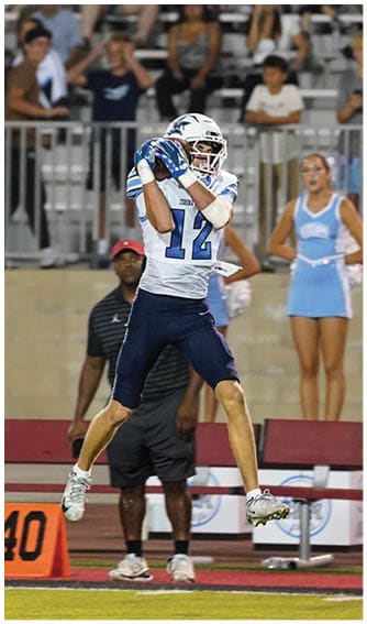 A football player running on the field. Description generated by AI